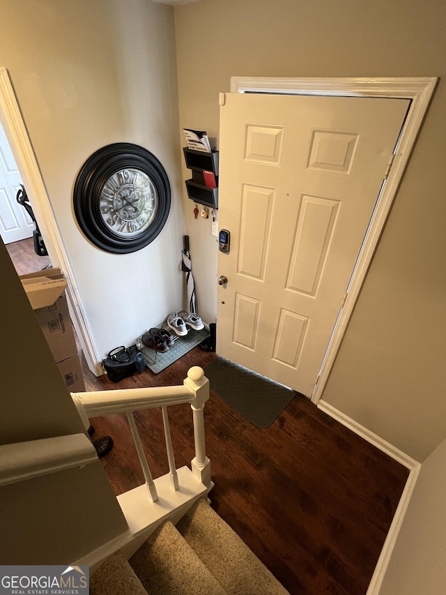 foyer with dark wood-style floors and stairs