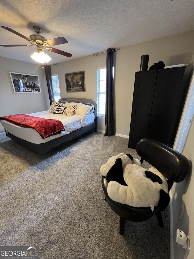 bedroom featuring baseboards, carpet flooring, a textured ceiling, and a ceiling fan