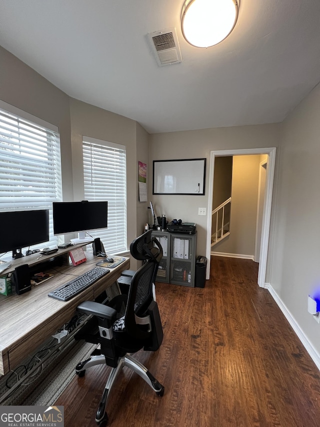 office space with visible vents, baseboards, and wood finished floors