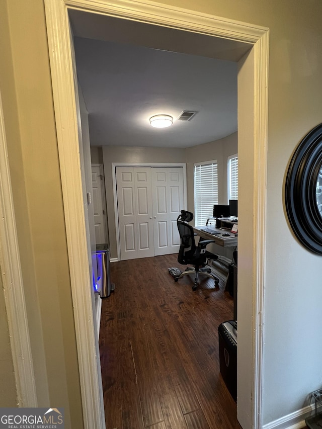 home office featuring visible vents, baseboards, and dark wood-style flooring