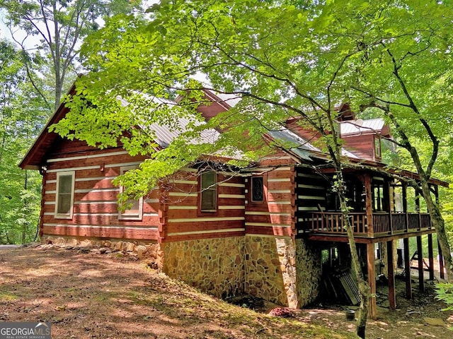 view of home's exterior with log siding