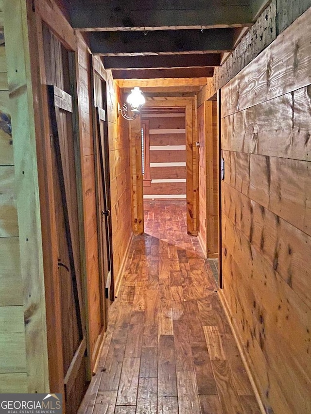 hall featuring wood-type flooring and wooden walls