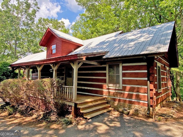 view of front of house featuring metal roof and a porch