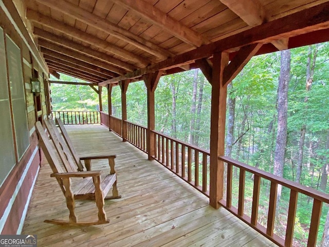 wooden deck with a view of trees