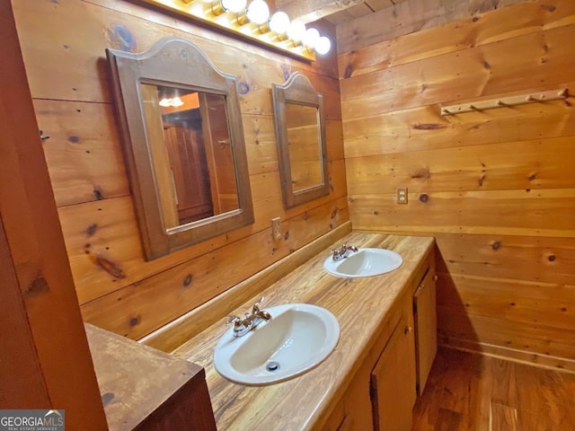 bathroom with wood walls and a sink