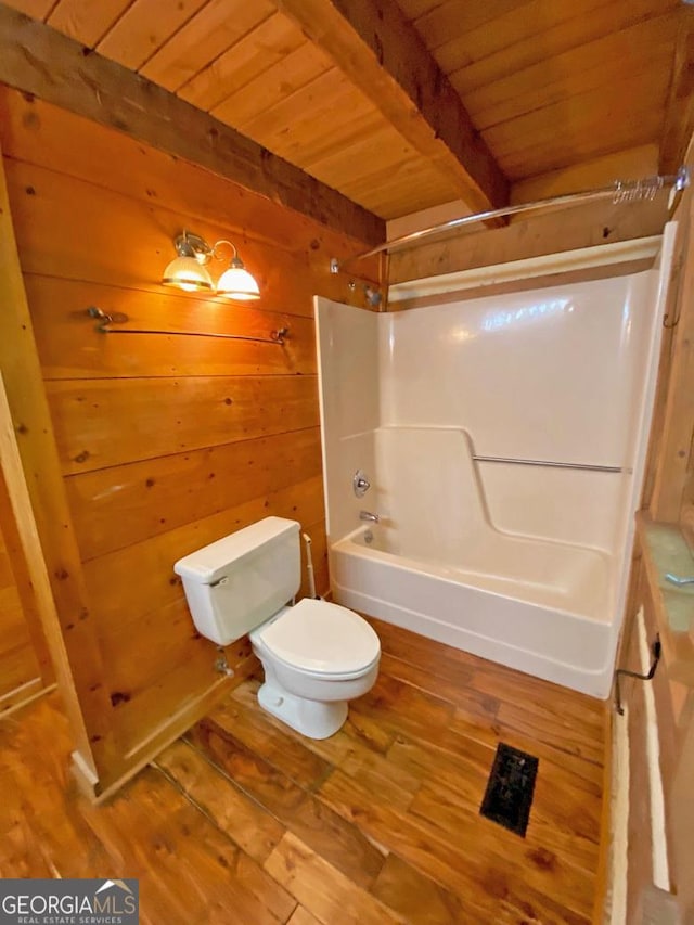 full bathroom featuring wooden walls, beamed ceiling, wood ceiling, toilet, and wood finished floors