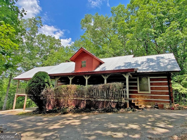 view of front facade featuring a porch and metal roof