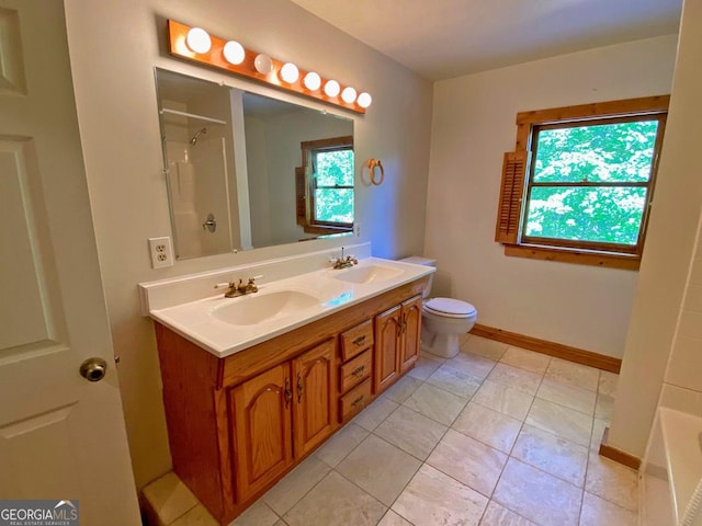 bathroom featuring a sink, baseboards, walk in shower, and double vanity