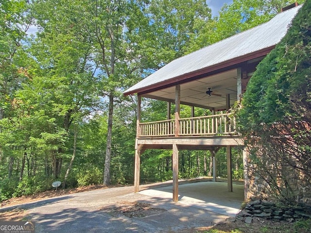 view of patio / terrace featuring aphalt driveway and a ceiling fan