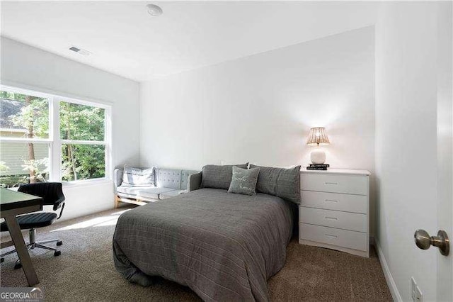 carpeted bedroom with baseboards and visible vents