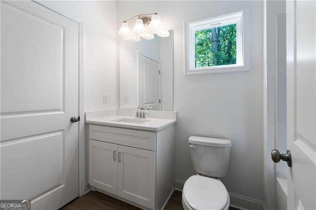 bathroom featuring vanity and toilet