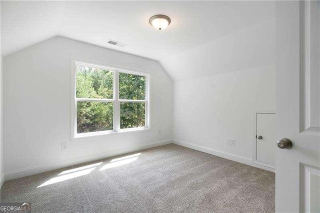 bonus room featuring vaulted ceiling, baseboards, visible vents, and carpet floors