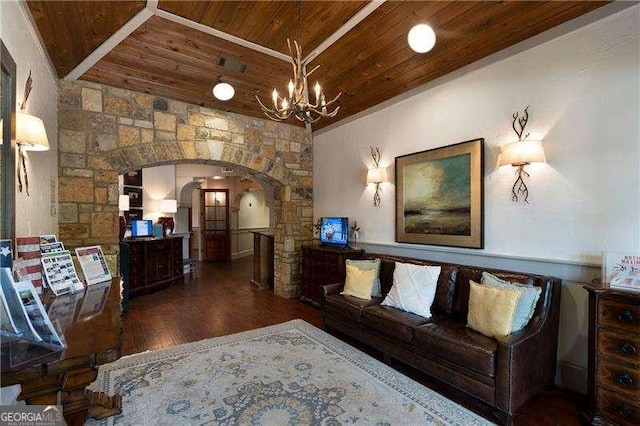 living area featuring arched walkways, a notable chandelier, wooden ceiling, and wood finished floors