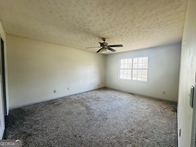 carpeted empty room featuring baseboards, a textured ceiling, and ceiling fan