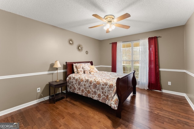 bedroom with baseboards, a textured ceiling, and wood finished floors