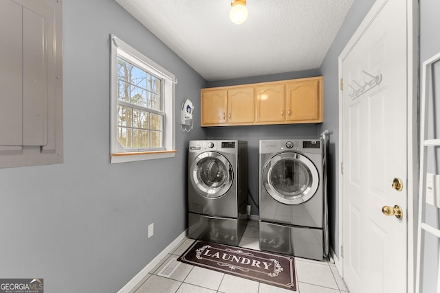 laundry area featuring electric panel, washer and dryer, light tile patterned flooring, cabinet space, and a textured ceiling