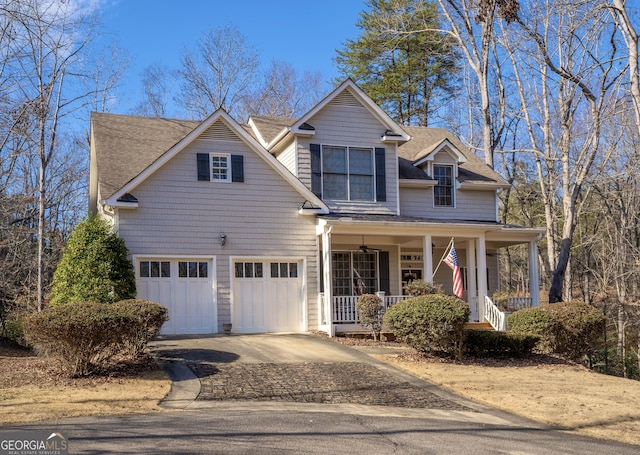 view of front of property with a porch, driveway, and roof with shingles