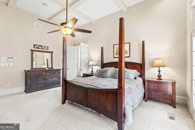 carpeted bedroom featuring visible vents, beam ceiling, coffered ceiling, baseboards, and a towering ceiling