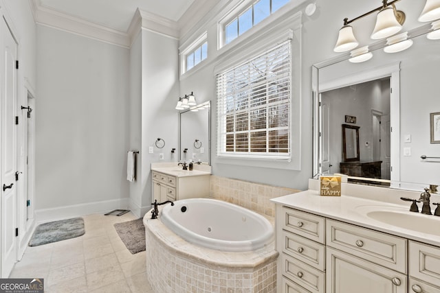 full bath featuring baseboards, two vanities, a whirlpool tub, ornamental molding, and a sink