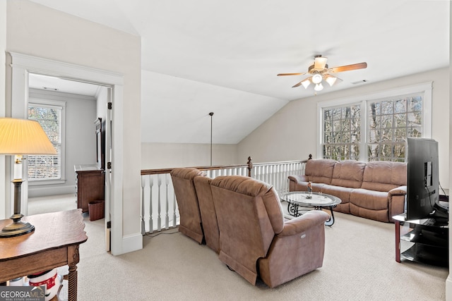 living area with visible vents, light carpet, a ceiling fan, baseboards, and vaulted ceiling