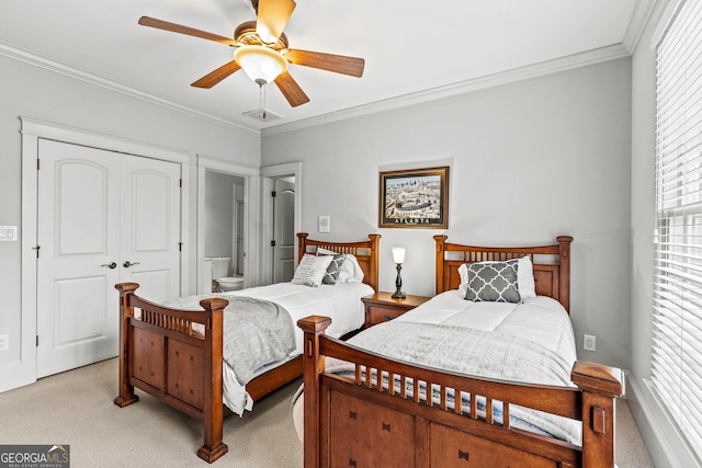 bedroom featuring ceiling fan, crown molding, a closet, and light carpet