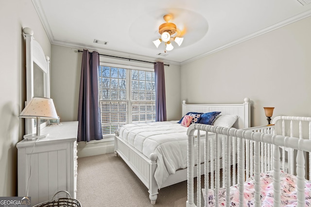 bedroom featuring visible vents, carpet flooring, crown molding, and a ceiling fan