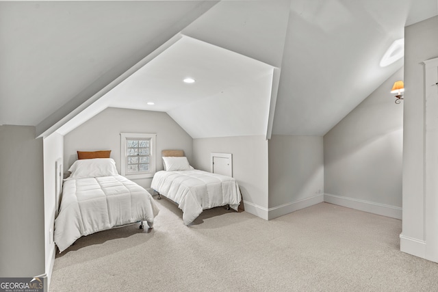 carpeted bedroom with baseboards and vaulted ceiling