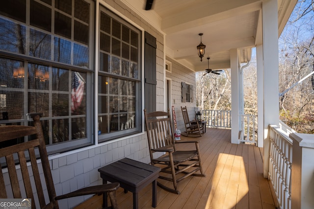 deck with covered porch and a ceiling fan