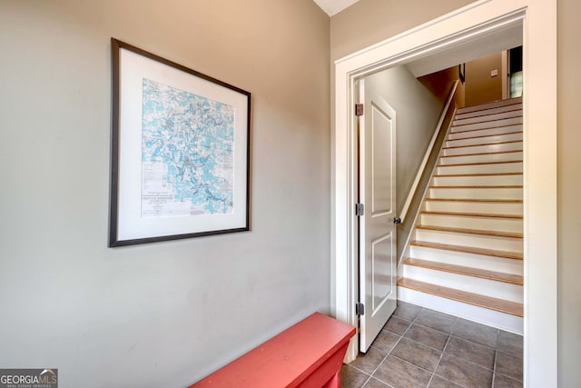 stairs featuring tile patterned floors