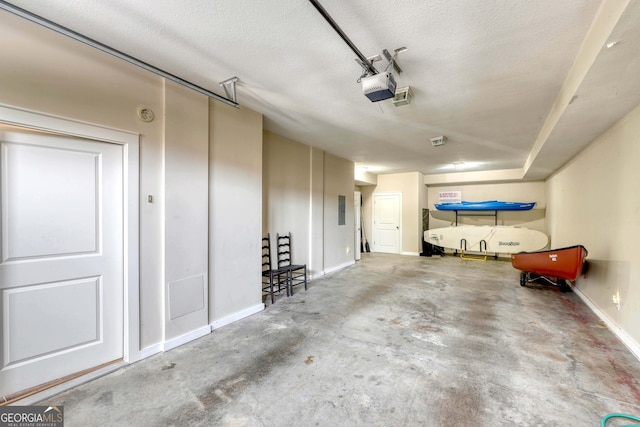 garage featuring baseboards and a garage door opener