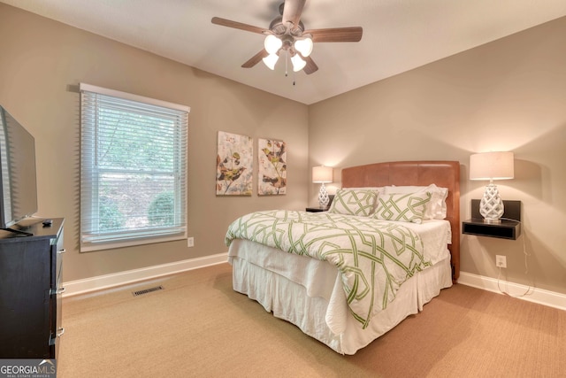 bedroom featuring a ceiling fan, carpet flooring, visible vents, and baseboards