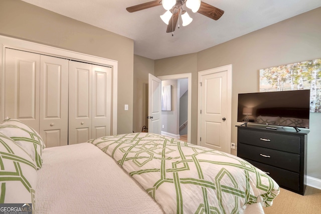 bedroom with a ceiling fan, a closet, and baseboards