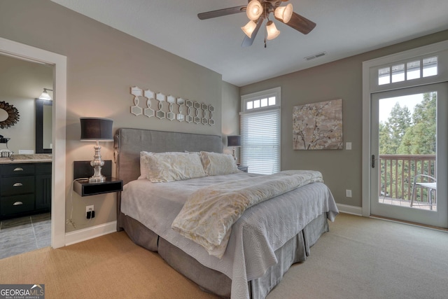 bedroom with visible vents, light colored carpet, baseboards, and access to outside