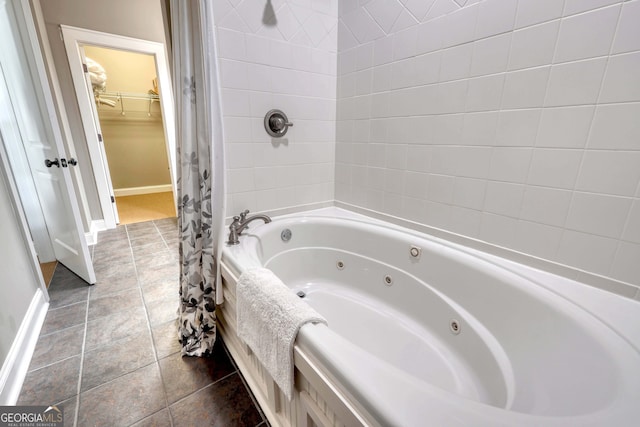 bathroom with tile patterned floors, baseboards, and a combined bath / shower with jetted tub