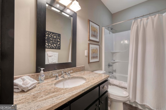 bathroom featuring vanity, toilet, and shower / tub combo