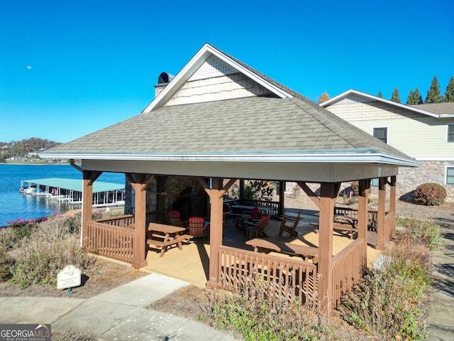 view of patio featuring a gazebo and a water view