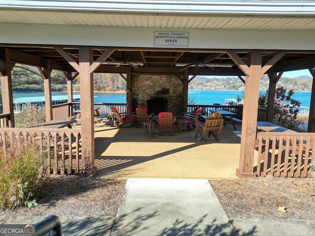 view of patio featuring a gazebo, a water view, and ceiling fan