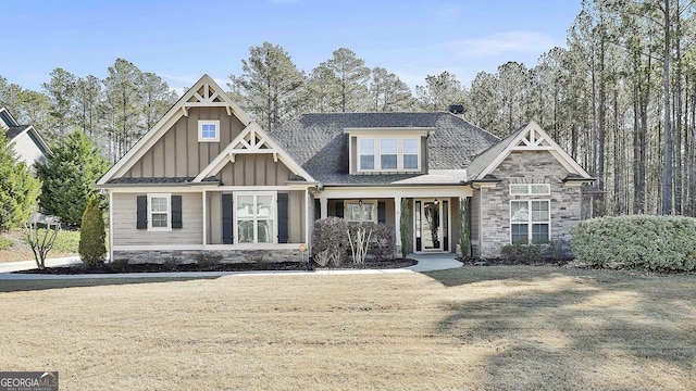 craftsman-style home featuring stone siding, roof with shingles, and board and batten siding