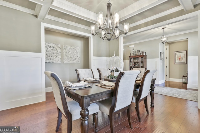 dining space featuring beam ceiling, wainscoting, wood-type flooring, and a chandelier