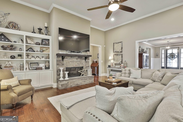 living room featuring a fireplace, crown molding, ceiling fan, and wood finished floors