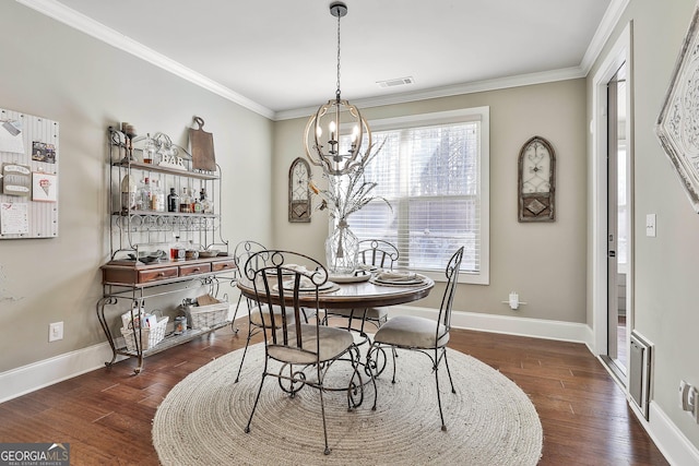 dining room featuring visible vents, a notable chandelier, wood finished floors, and ornamental molding