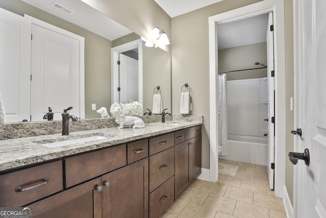 full bathroom featuring double vanity, shower / bath combo, visible vents, and a sink