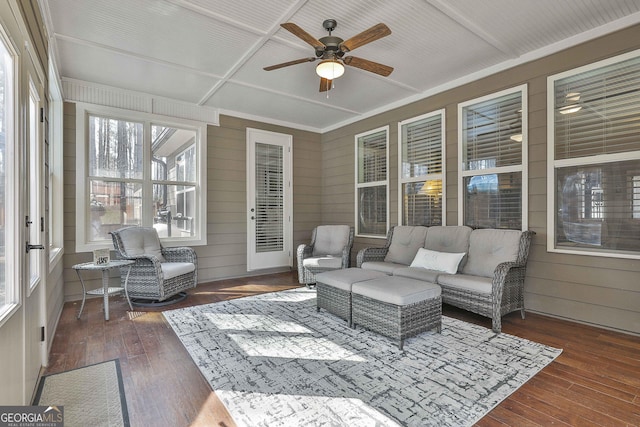 sunroom / solarium featuring a ceiling fan