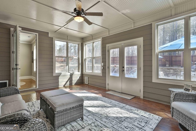 sunroom / solarium with a wealth of natural light, french doors, wooden ceiling, and a ceiling fan