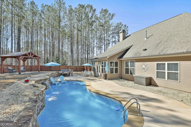 view of swimming pool featuring a gazebo, a fenced in pool, a fenced backyard, and a patio area