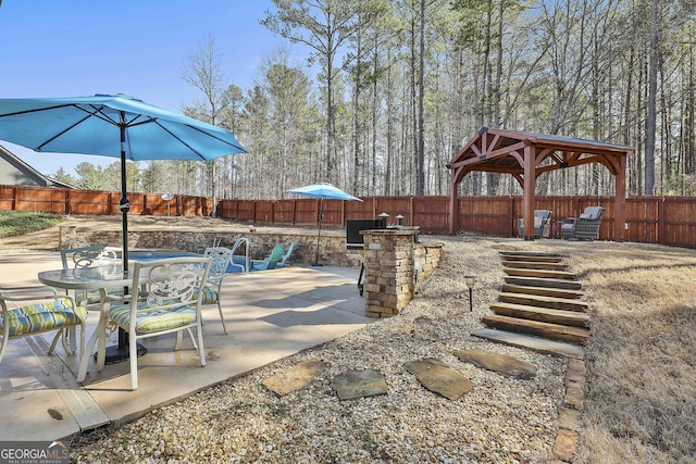 view of patio featuring outdoor dining space and a fenced backyard