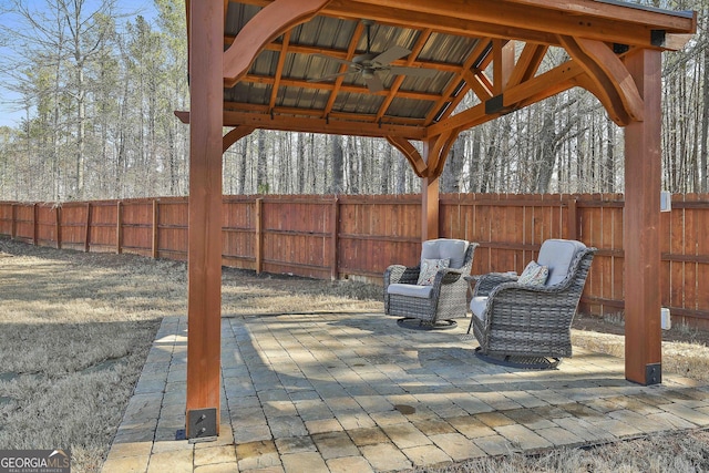 view of patio / terrace with ceiling fan, a gazebo, and a fenced backyard