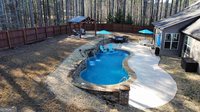 view of pool featuring a patio area, a fenced in pool, and a fenced backyard