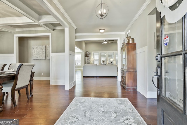 foyer with beam ceiling, coffered ceiling, crown molding, ceiling fan, and dark wood-style flooring