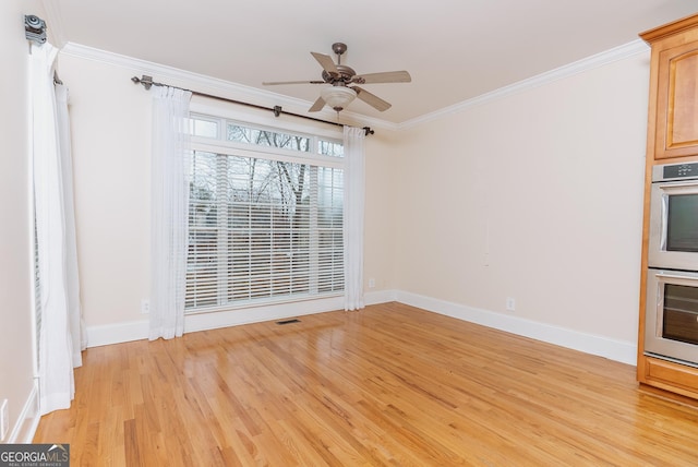 unfurnished dining area featuring ceiling fan, baseboards, light wood finished floors, and ornamental molding